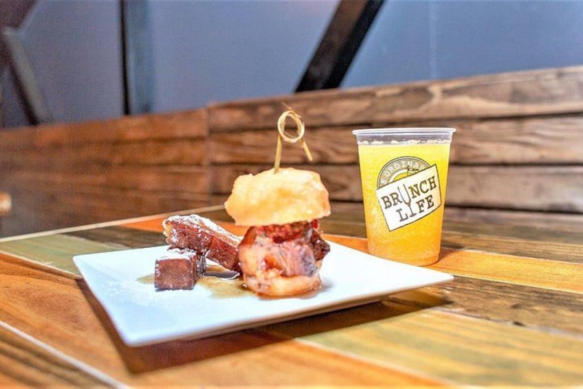 A plate with a burger and a drink on a wooden table. 3