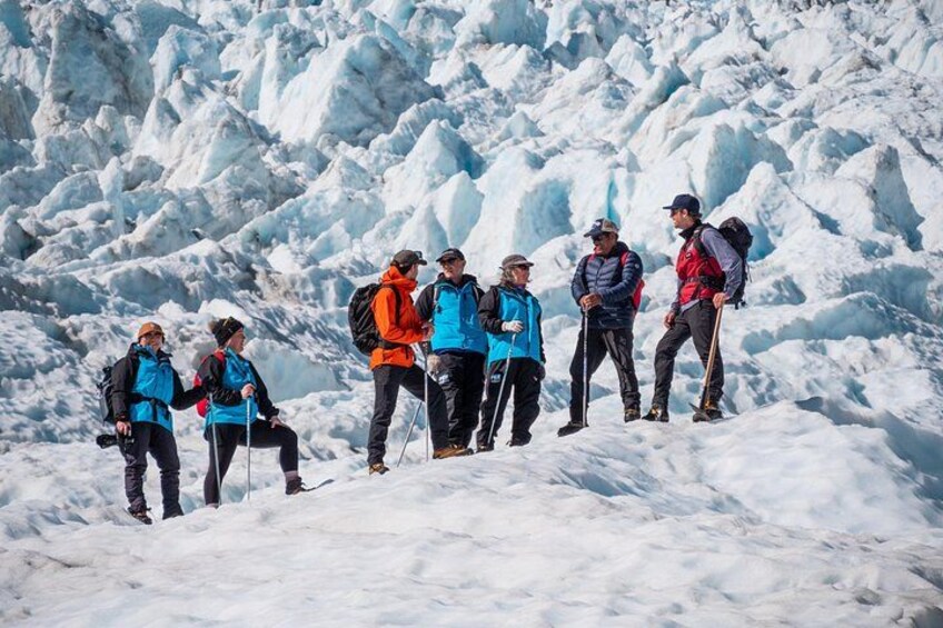 A group of hikers on a snowy mountain with ice formations. 1