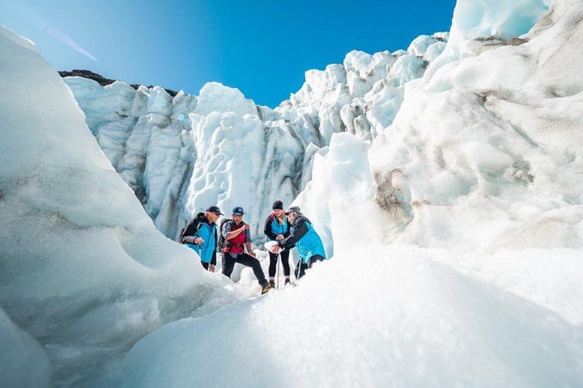 A group of people hiking through a glacier. 2