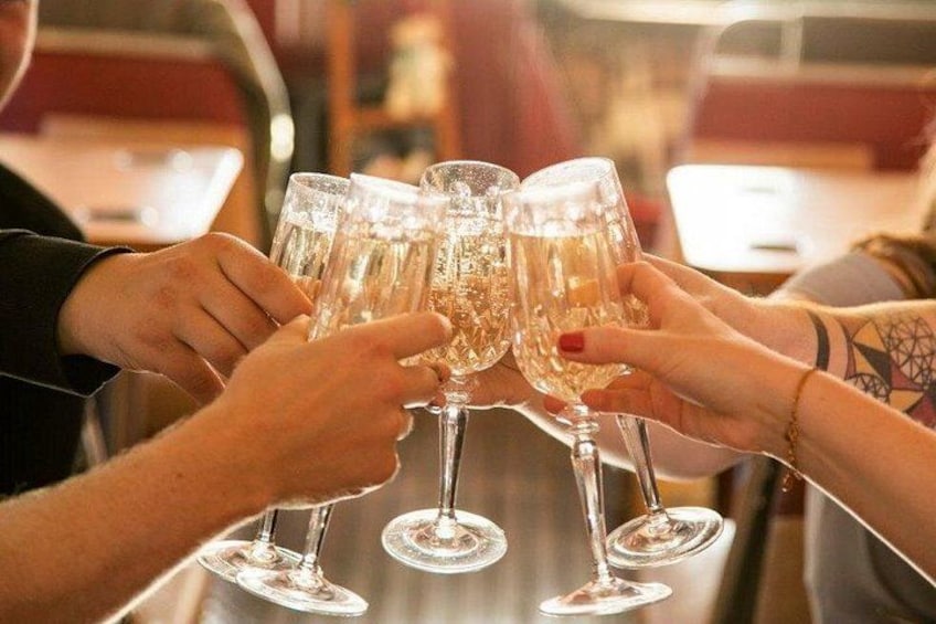 A group of people clinking glasses together. 1