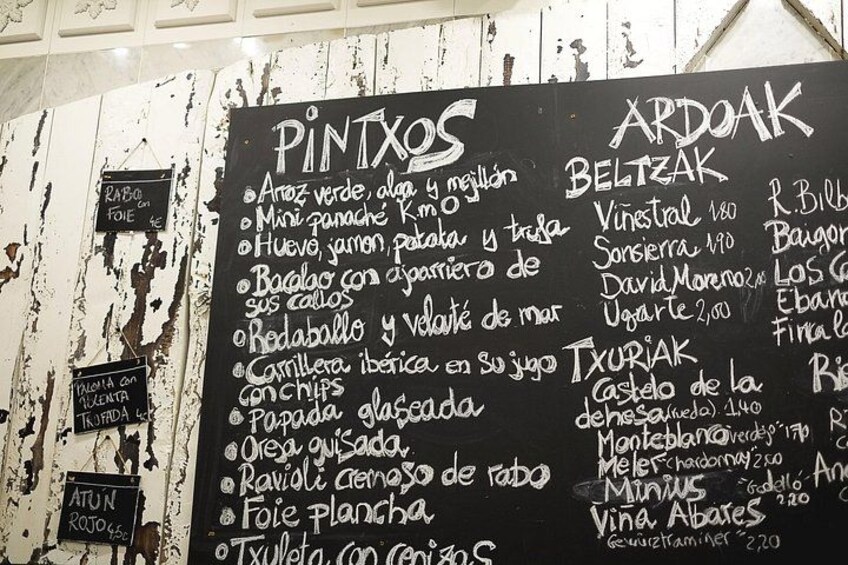 A chalkboard menu with various food items listed. 2