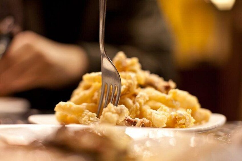 A close-up of a fork digging into a mound of mashed potatoes with a creamy texture. 3