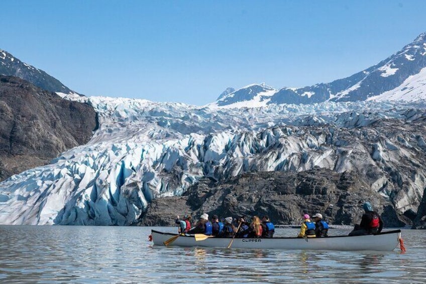 A group of people in a boat on a glacier. 5