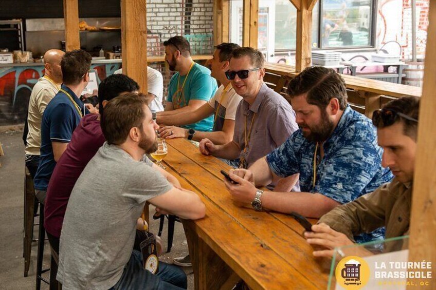 A group of people seated at a wooden table inside a restaurant. 2