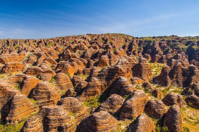 A landscape of tall, conical rock formations. 3