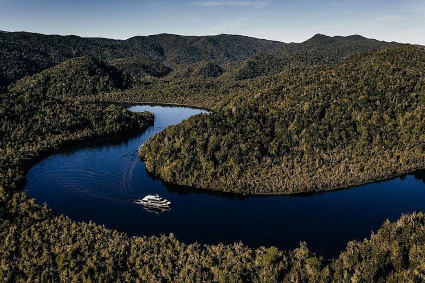 A lake surrounded by dense forest and mountains. 2