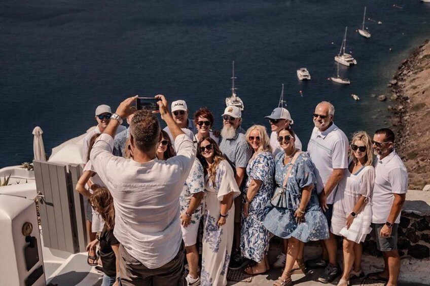 A group of people on a boat with the sea and boats in the background. 2