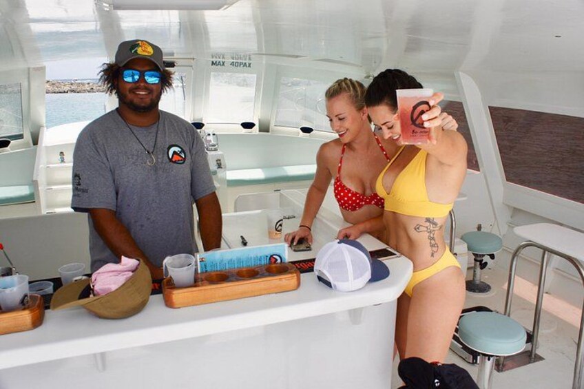 A boat interior with a bar area, a person in a red swimsuit, and another in a yellow swimsuit. 5