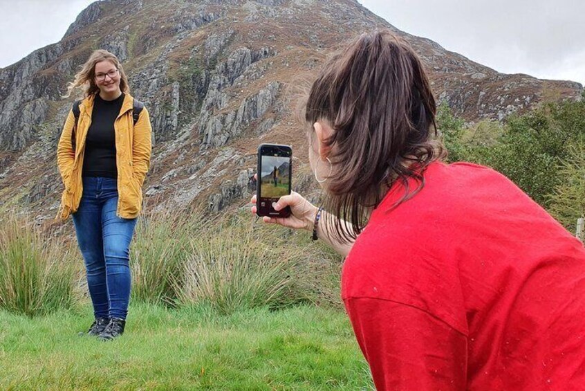 A person taking a photo of another person in a mountainous area. 5