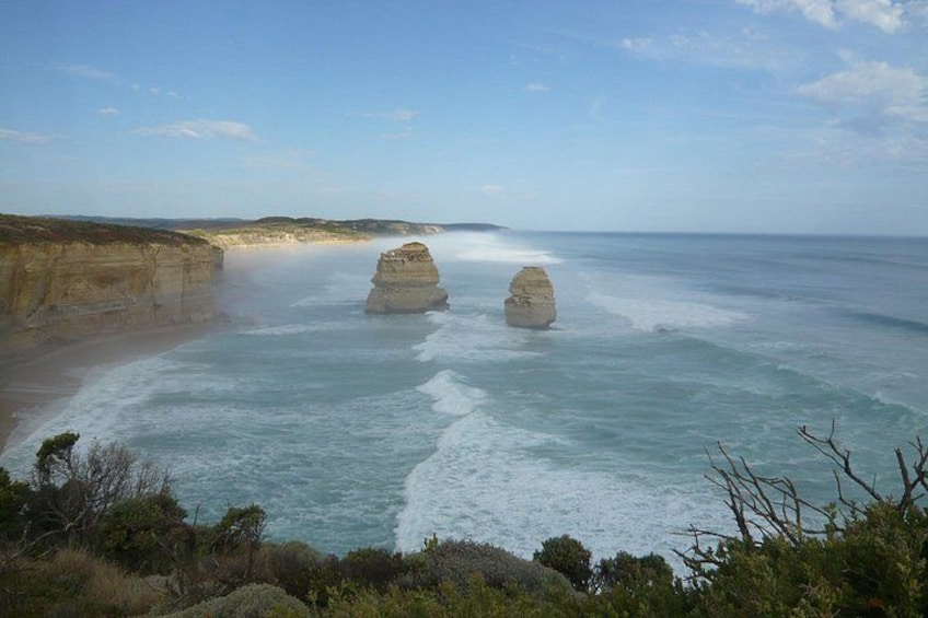 A coastal landscape with cliffs and two prominent rock formations in the sea. 3