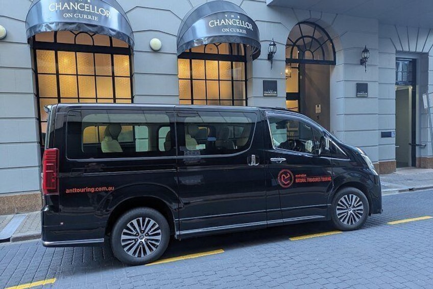 A black van parked in front of a building with 'CHANCELLOR ON CURRIE' signage. 4