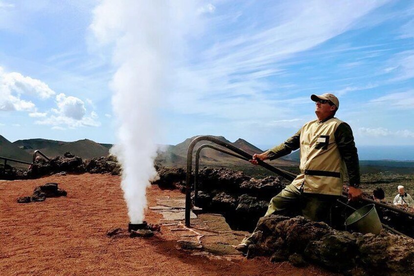 A person operating a steam engine in a volcanic landscape. 1
