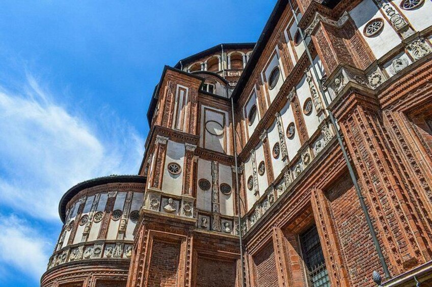 A historic building with intricate brickwork and circular windows. 3