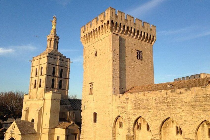 A historic building with a prominent tower and a statue on top. 2