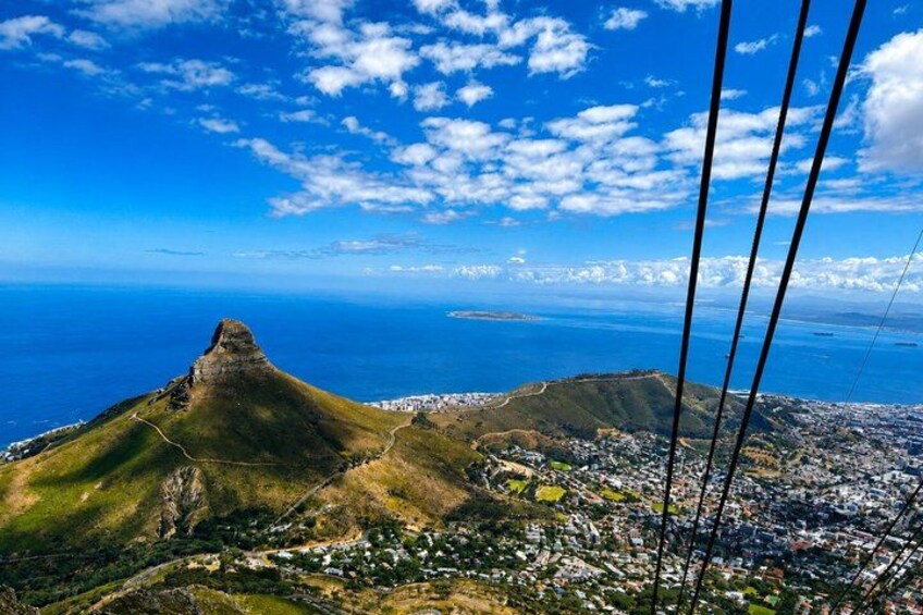 A mountain peak, a coastal city, and a clear blue sky. 2