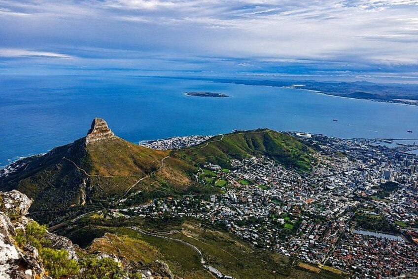 A coastal city with a prominent hill, a harbor, and a large body of water. 4