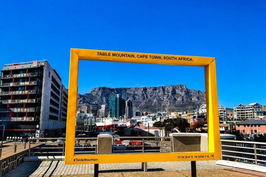 A yellow frame with the text 'Table Mountain, Cape Town, South Africa' and a view of Table Mountain in the background. 3