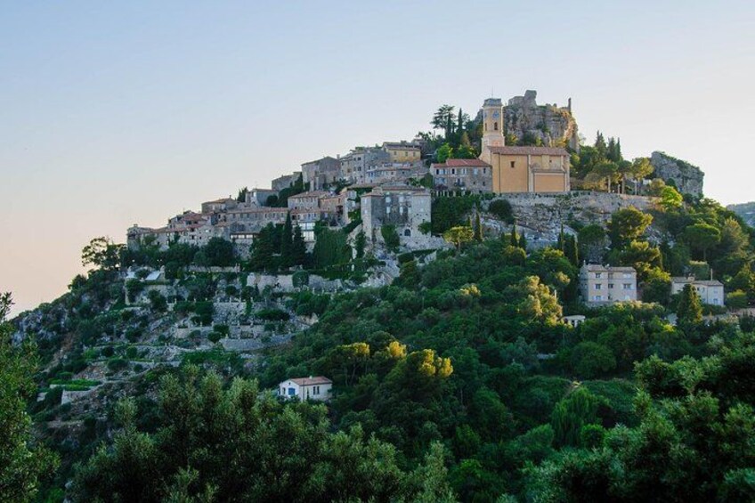 A historic town perched on a hillside with ancient ruins and modern buildings. 2