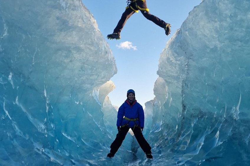 A person ice climbing between two large ice walls. 1