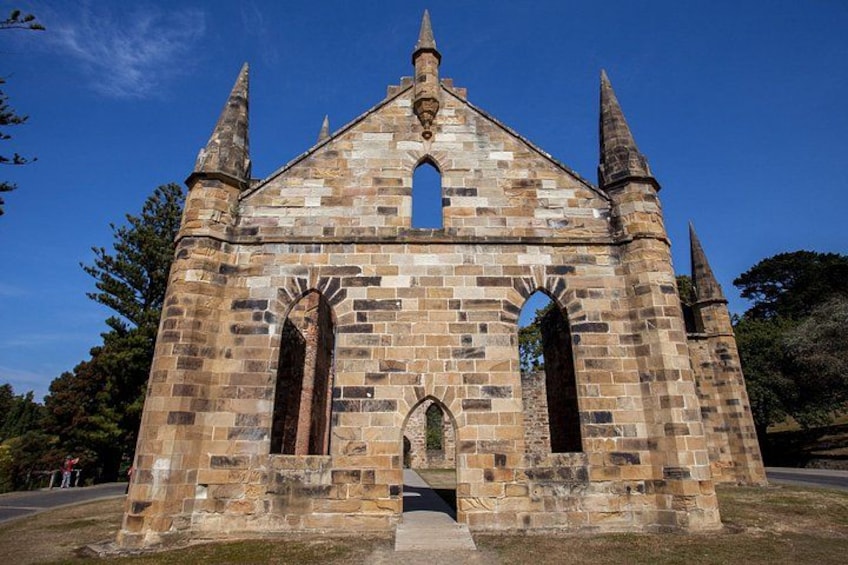 A historic stone church with pointed arches and a central tower. 2