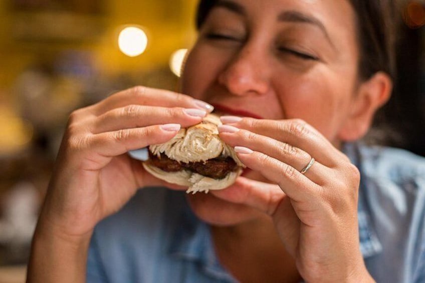 A person holding a sandwich. 2
