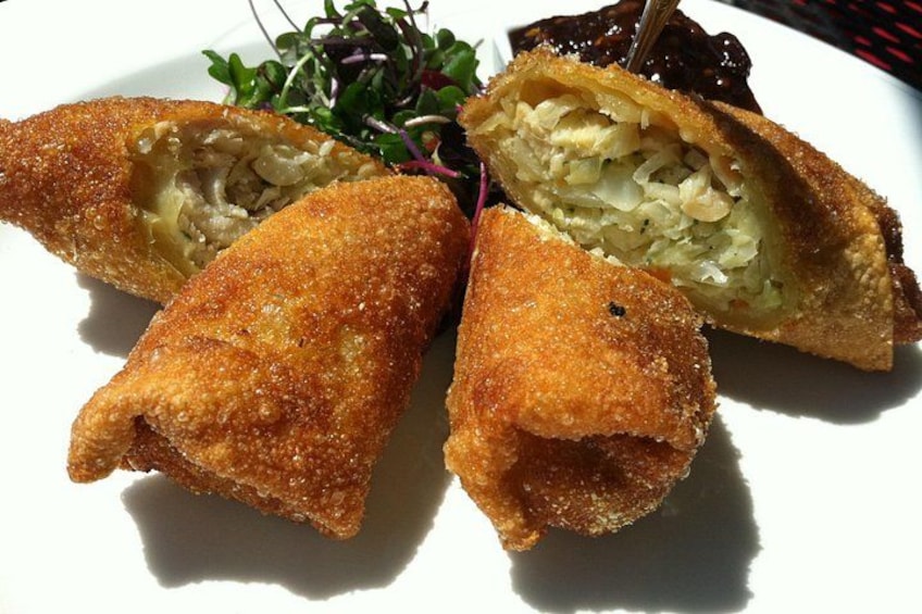 A plate with three pieces of breaded and fried food, possibly croquettes, and a side salad. 2