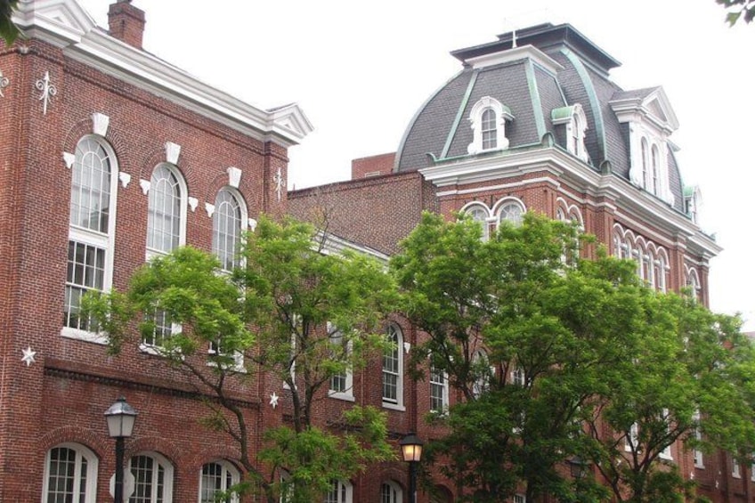 A red brick building with arched windows and a dome. 3
