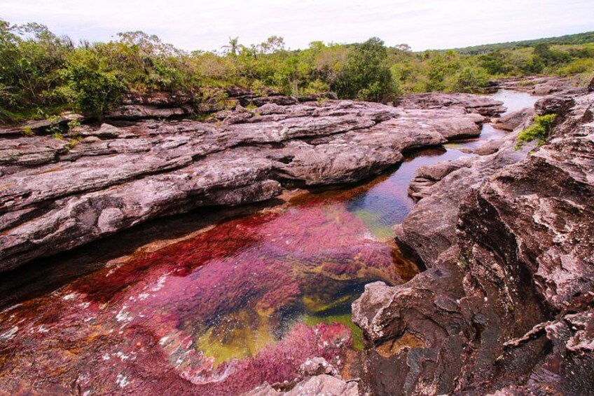A natural landscape with a rocky terrain and a water body. 4