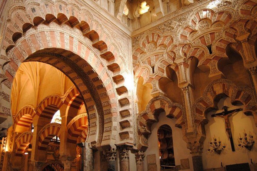 A grand interior with ornate arches and detailed stonework. 3