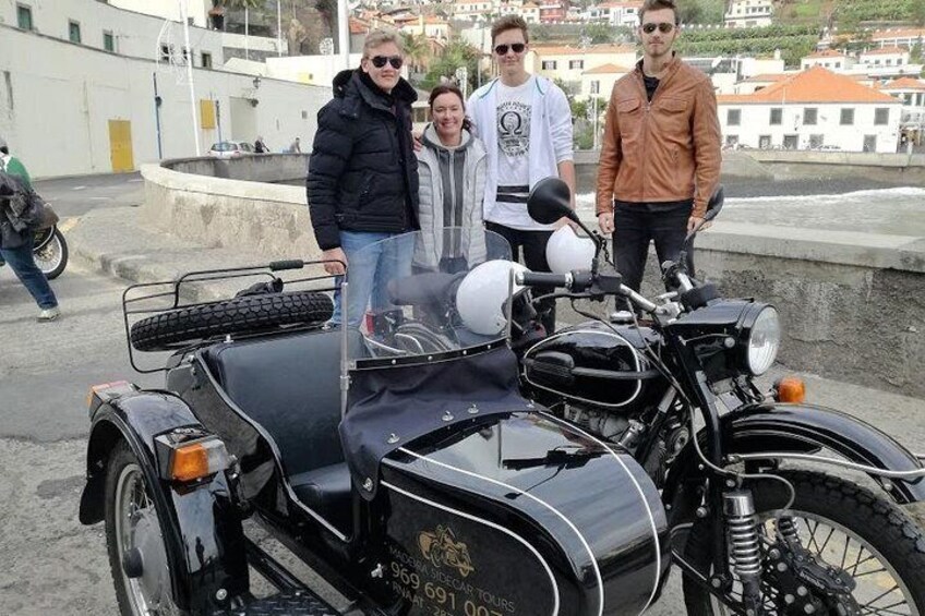 A vintage motorcycle with a sidecar parked on a rooftop. 5
