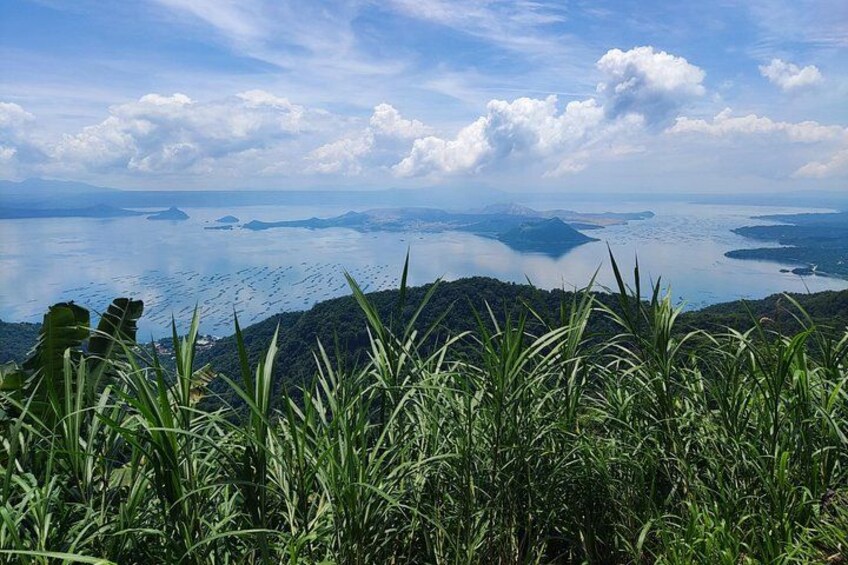 A coastal landscape with mountains, a body of water, and vegetation. 4