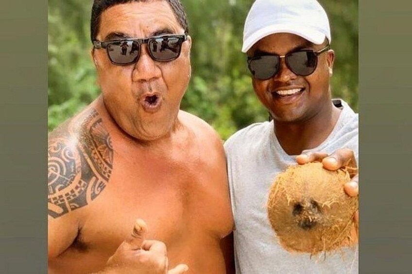 Two people, one with a tattoo and the other holding a coconut. 2
