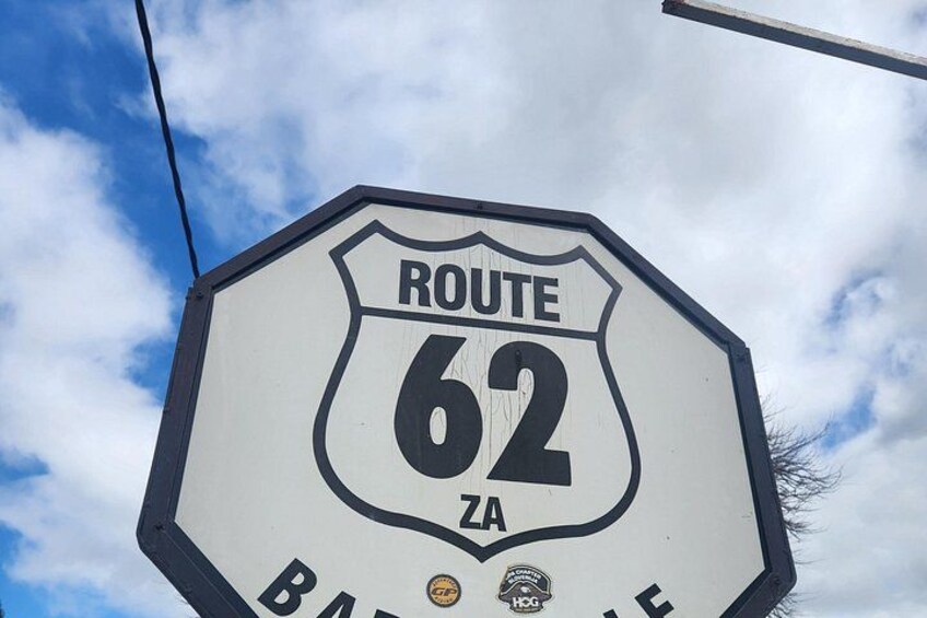 A Route 62 sign with a blue sky and clouds in the background. 2