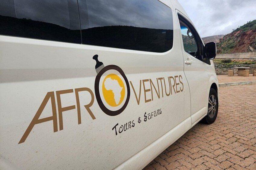 A white van with 'AFROVENTURES' and 'Tours & Safaris' written on its side. 3