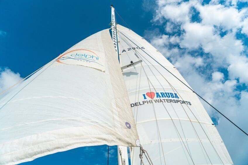 A sailboat with 'I love Aruba' and 'Delphi Watersports' written on its sails. 2