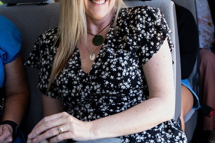A person wearing a floral dress seated on a chair. 5