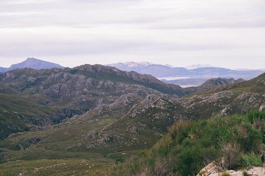 A mountainous landscape with rocky terrain and sparse vegetation. 2