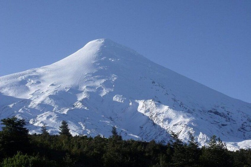 A snow-covered mountain with a clear sky. 3