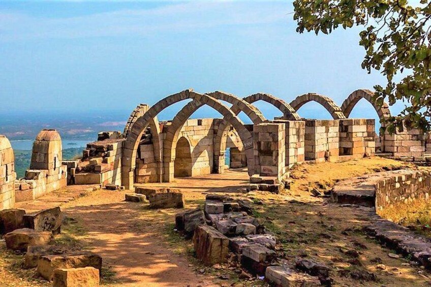 Ancient stone ruins with arches and a pathway. 1