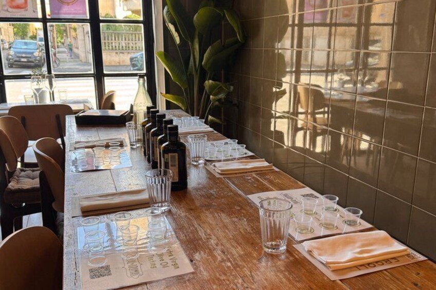 A restaurant table set with glasses, bottles, and menus. 1