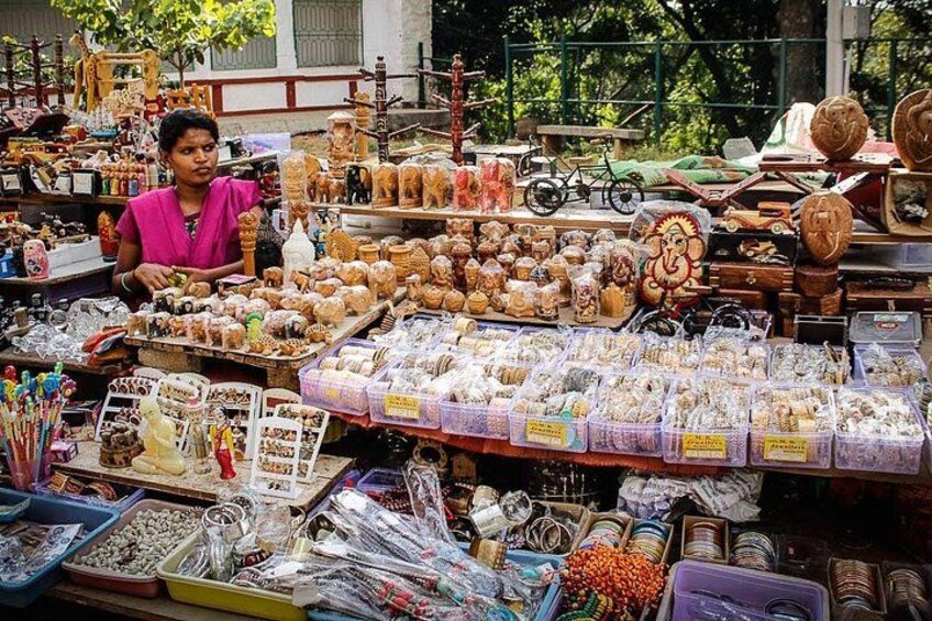 A market stall with various items including jewelry, snacks, and toys. 2