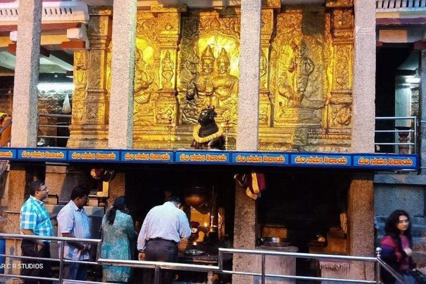 A temple with golden statues and intricate carvings. 3