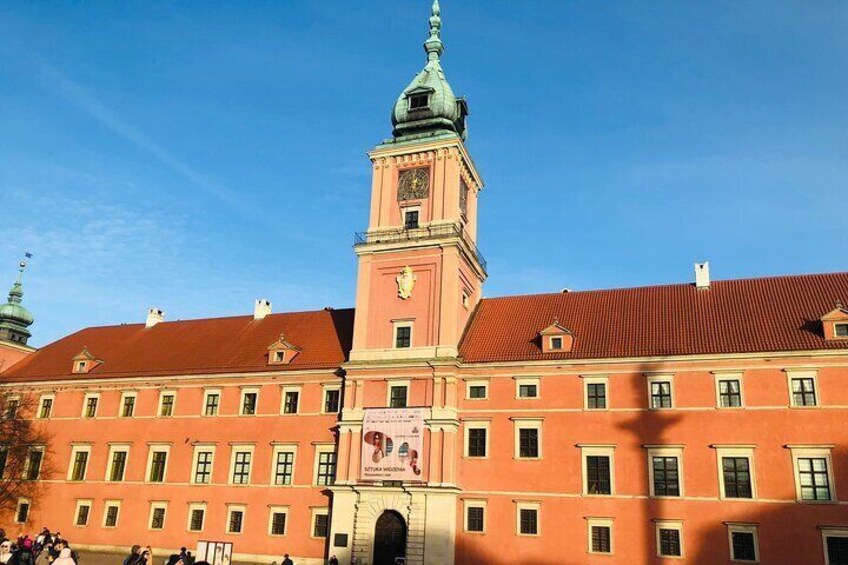 A historic building with a prominent tower and a red roof. 2
