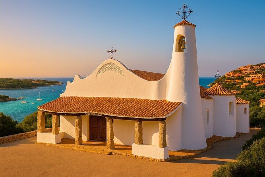 A white church with a bell tower and a cross on top, surrounded by a coastal landscape. 3