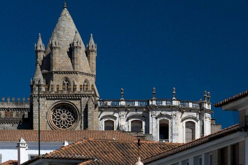 A historic cathedral with a large rose window and a pointed spire. 5