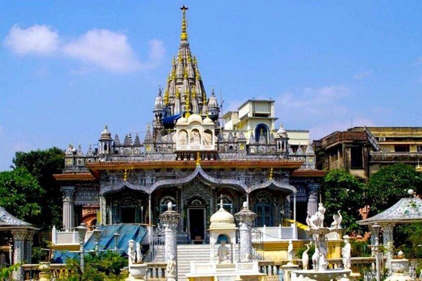A temple with a tall spire, intricate carvings, and statues. 2