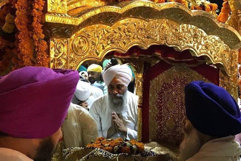Eine religiöse Zeremonie mit aufwendiger goldener Dekoration und Teilnehmern in traditioneller Kleidung. 2