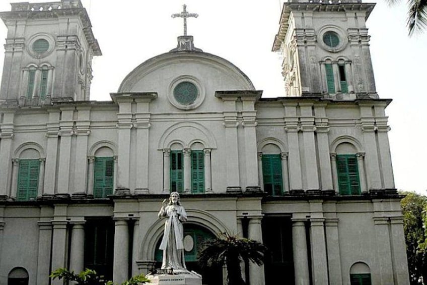 A church with a dome, two towers, and a statue in front. 3