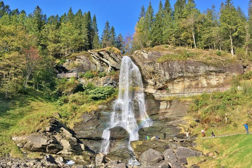 A waterfall cascading down a rocky cliff surrounded by trees. 4