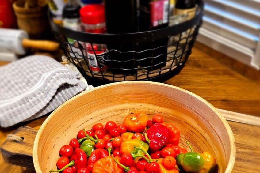 A wooden bowl filled with cherry tomatoes and bell peppers on a wooden cutting board. 5